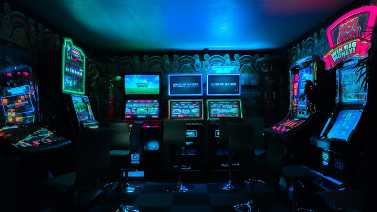 Neon-lit gaming workspace with controllers and charts