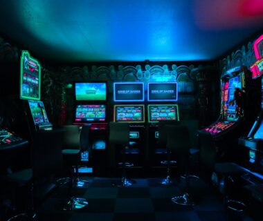 Neon-lit gaming workspace with controllers and charts