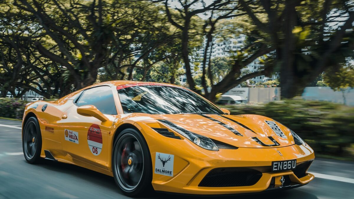 Red Ferrari on a mountain highway (photo: Alex Jodoin via Unsplash)