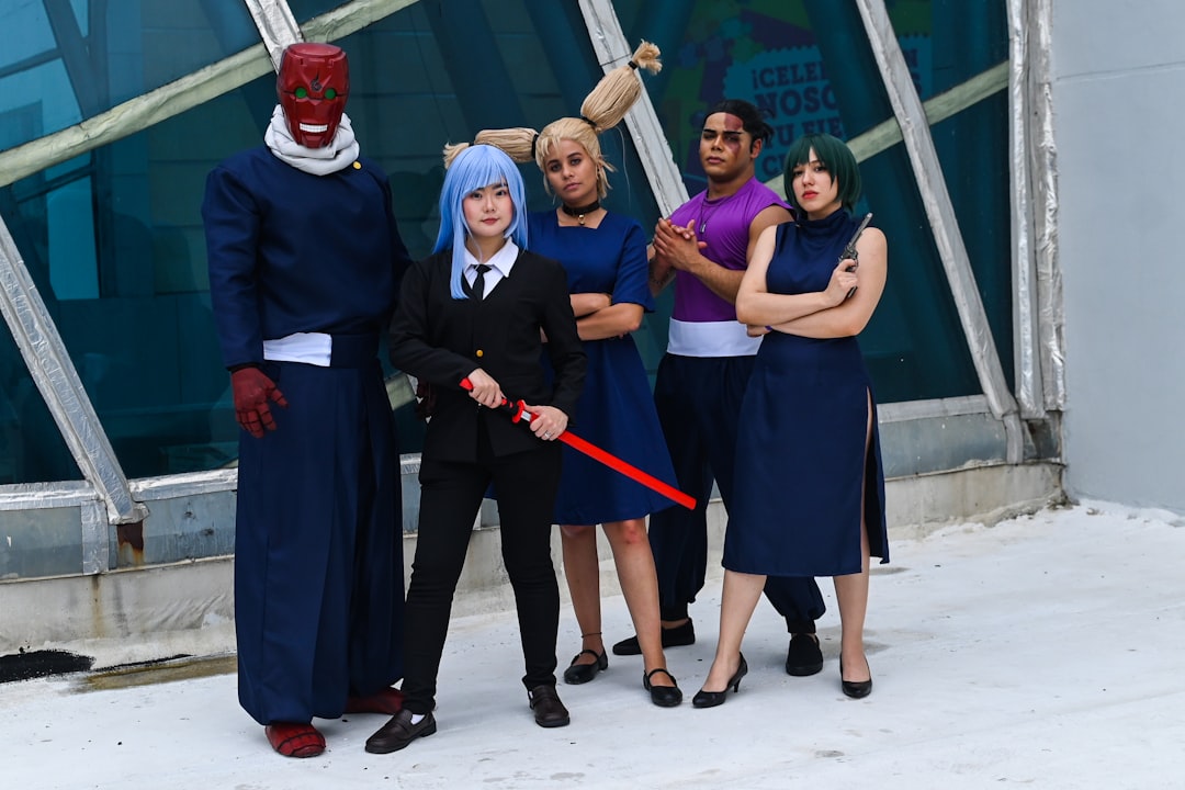 A group of people standing next to each other in front of a building